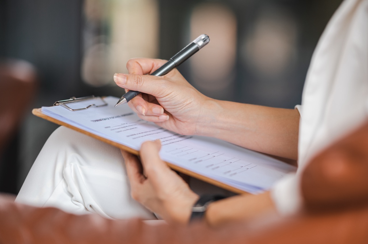 psychologist-making-notes-medical-history-while-understanding-problems-woman-patient Large.jpeg